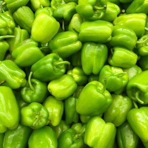 green bell pepper on brown wooden table