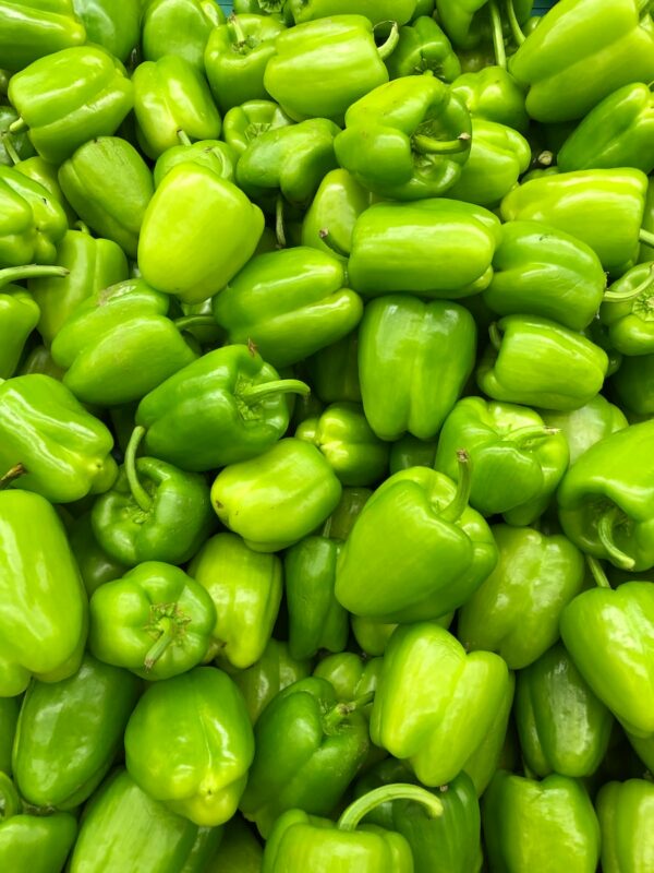 green bell pepper on brown wooden table